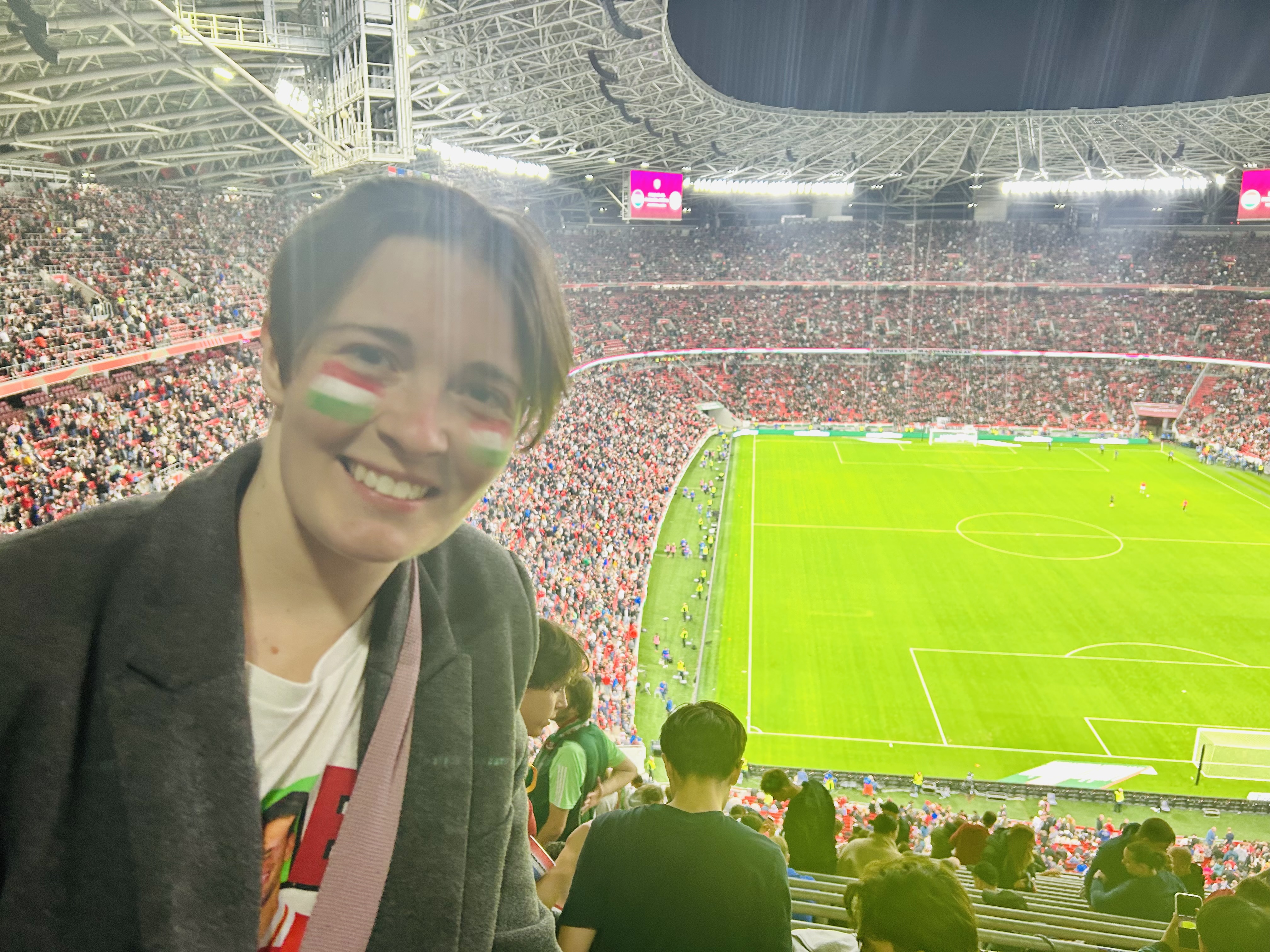 Viktória at a football match in a packed stadium
