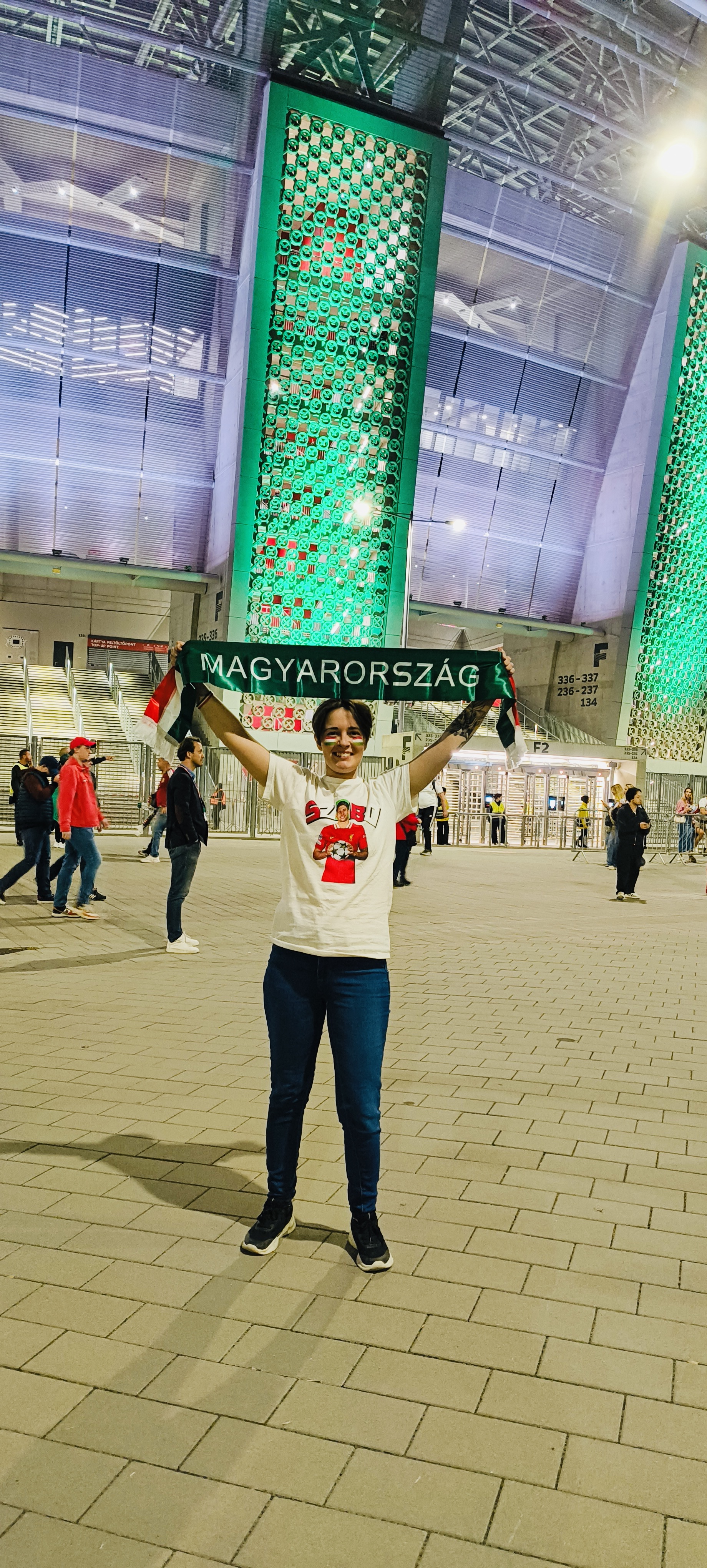 Viktória holding a Hungary football scarf outside the stadium